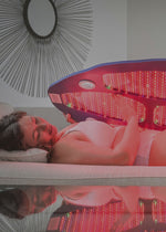 Woman in white clothing using a large Celluma light therapy device